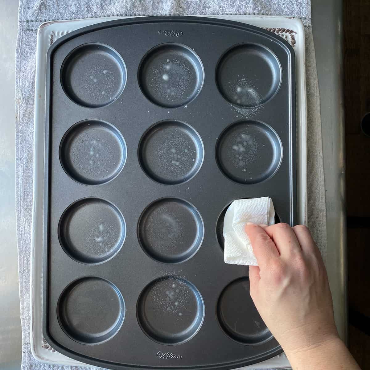 greasing pan before putting brownie mix in
