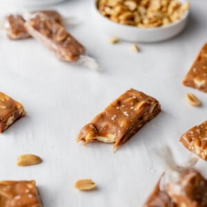 salted peanut caramel candy bars on table