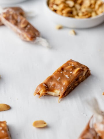 salted peanut caramel candy bars on table