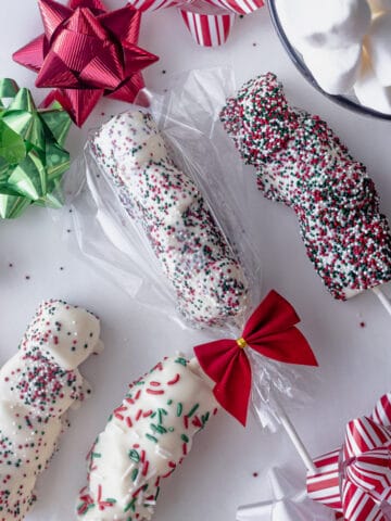 white fudge marshmallows with sprinkles on a stick